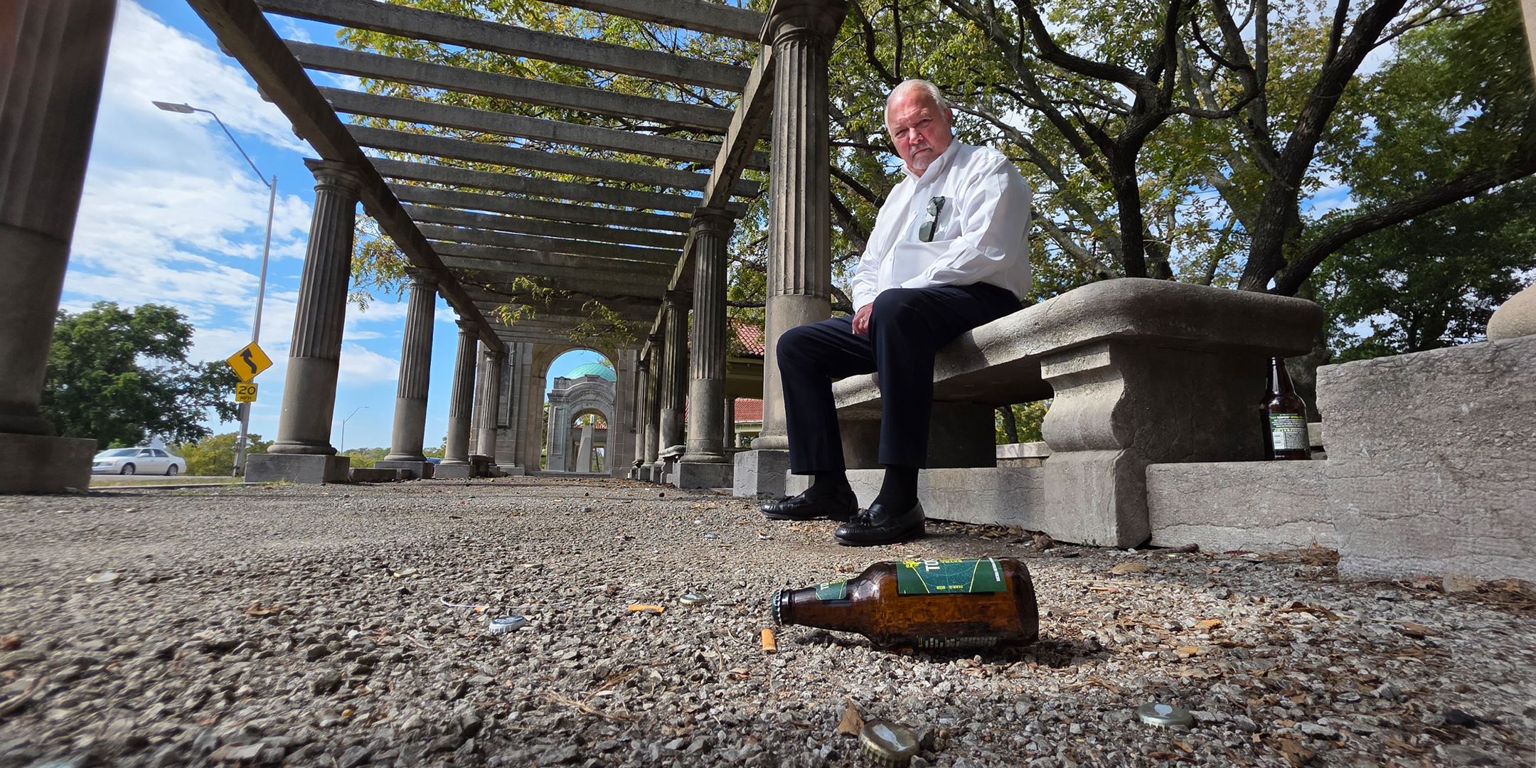 Larry Beaty sitting in litter-filled Colonnade